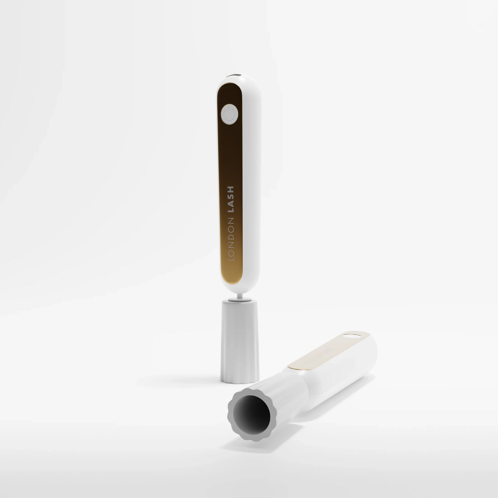 Eyelash extension glue shaker with a white and gold design on a light gray background