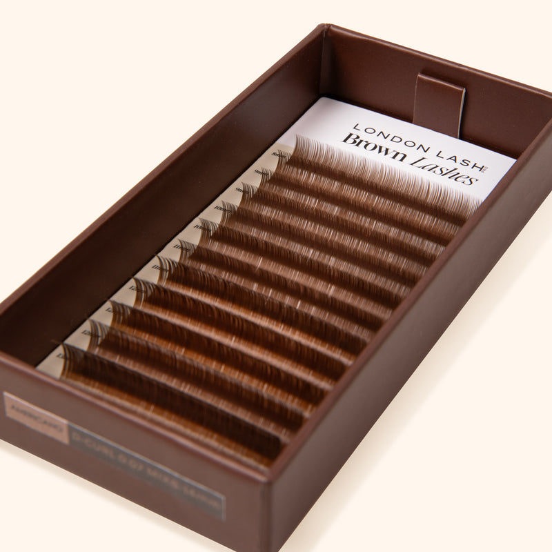 paper lash tray with lash card inside showing strips with brown eyelash extensions