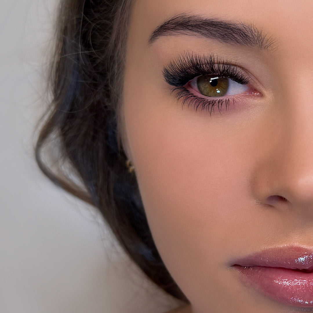 Half face of a model showing example of bottom eye lash extensions on her eye