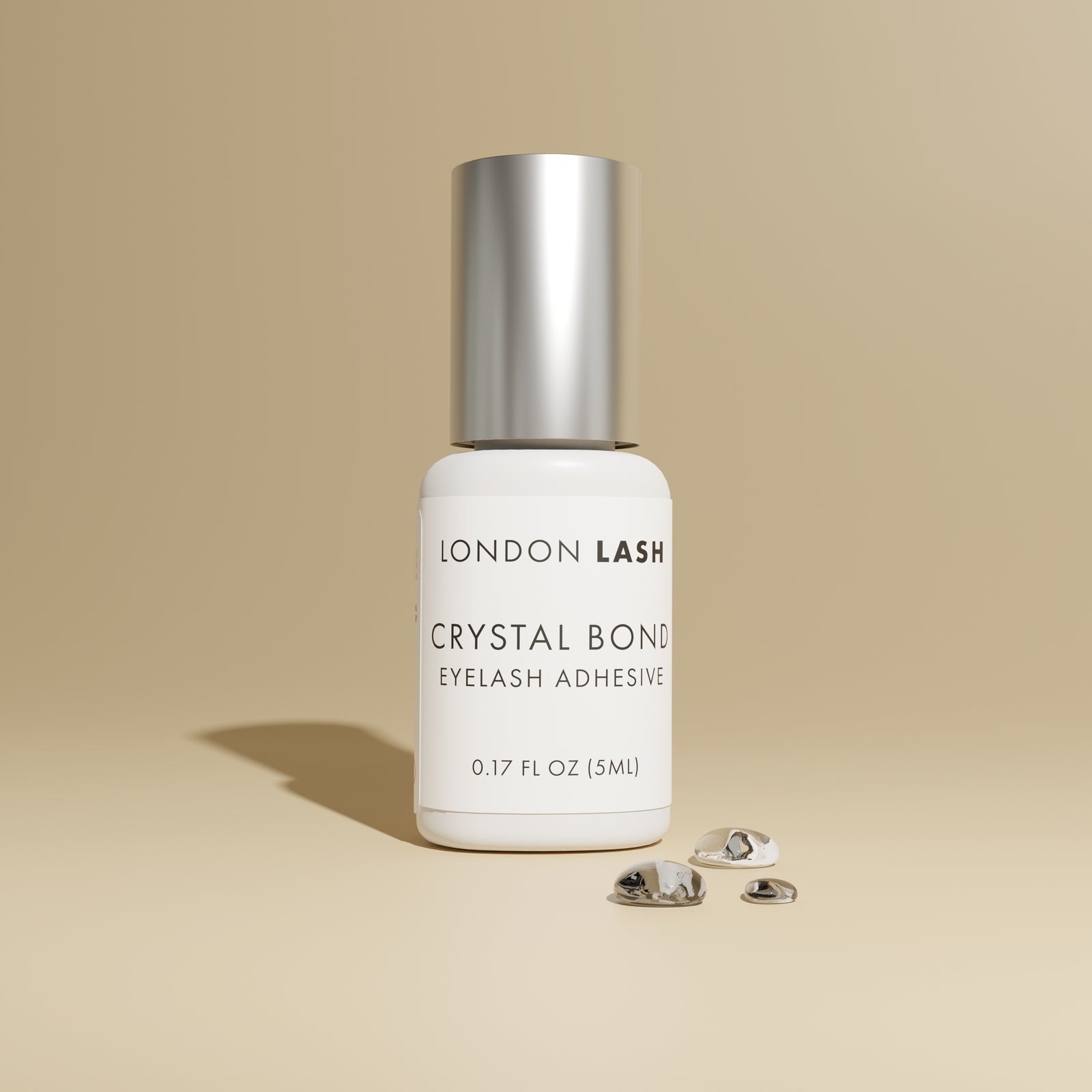 London Lash Glue Subscription - Crystal Bond Eyelash Adhesive bottle on beige background