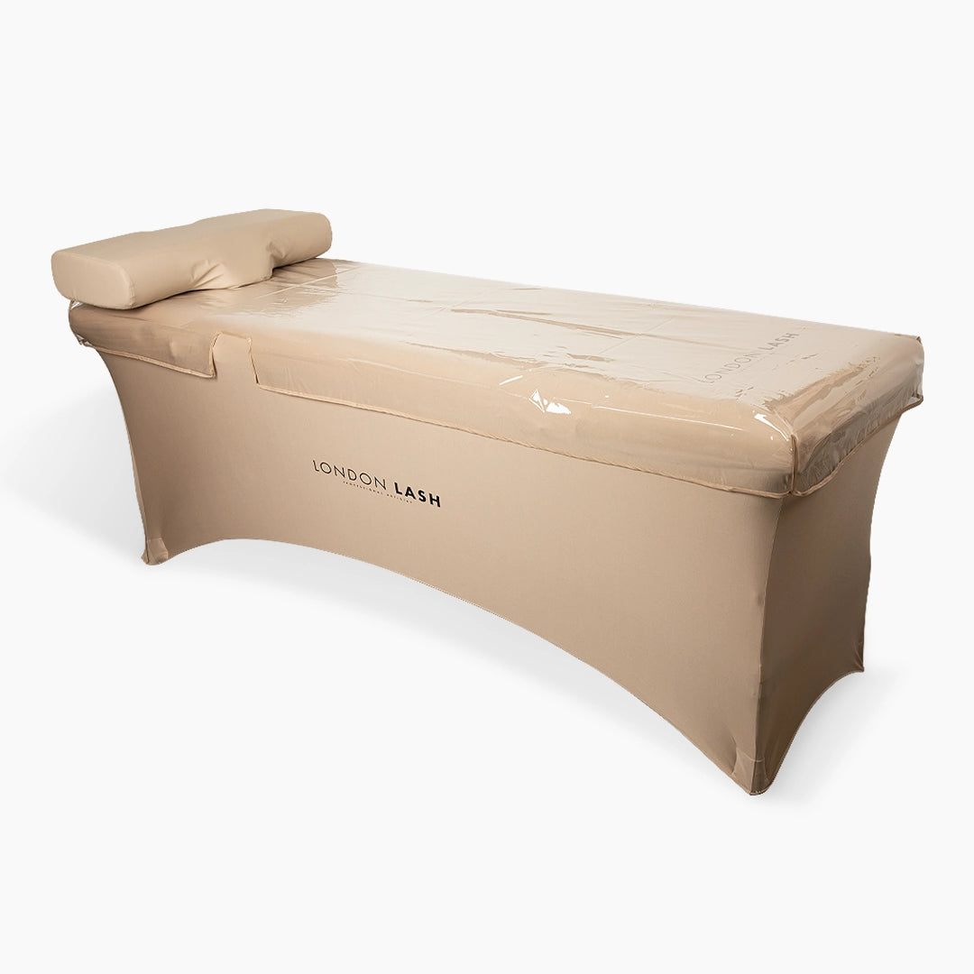 Clear Beauty Bed Cover on a beige beauty salon bed with 'London Lash' branding on a white background