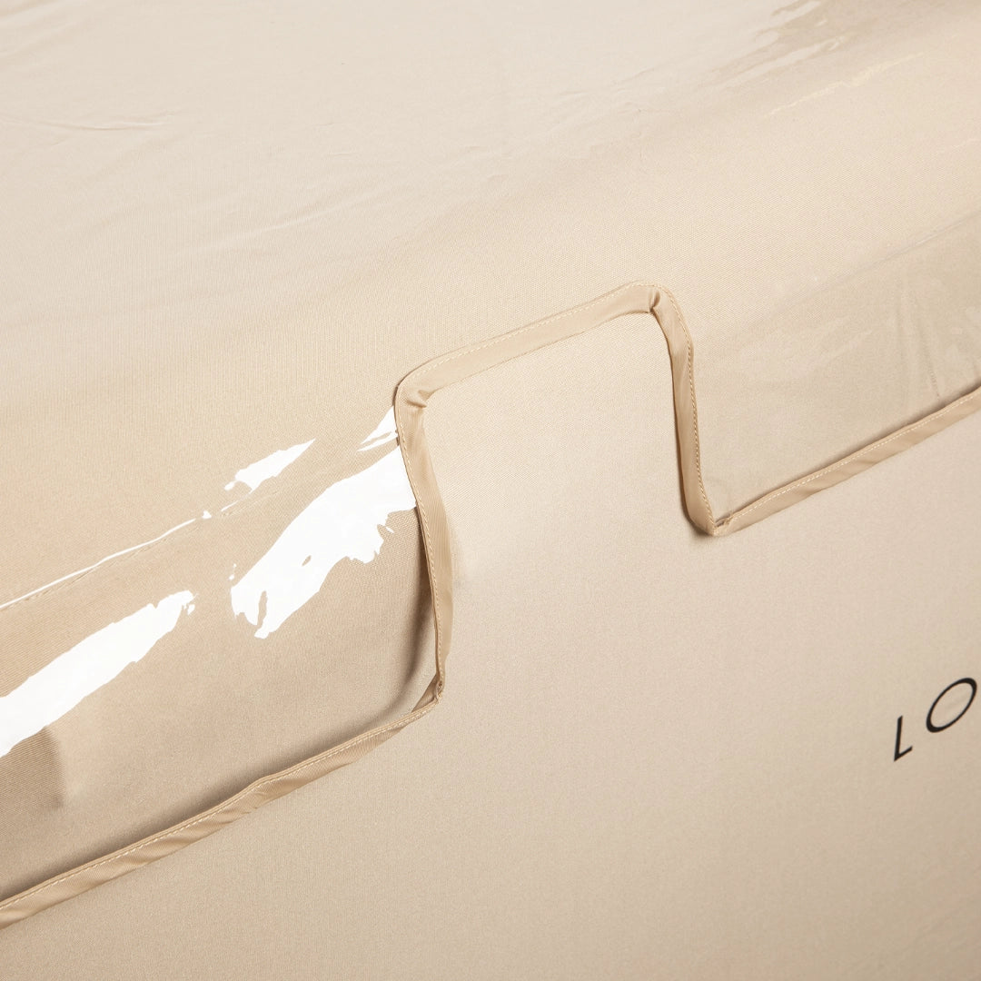 Beige massage table protected by 'London Lash' Clear Beauty Bed Cover