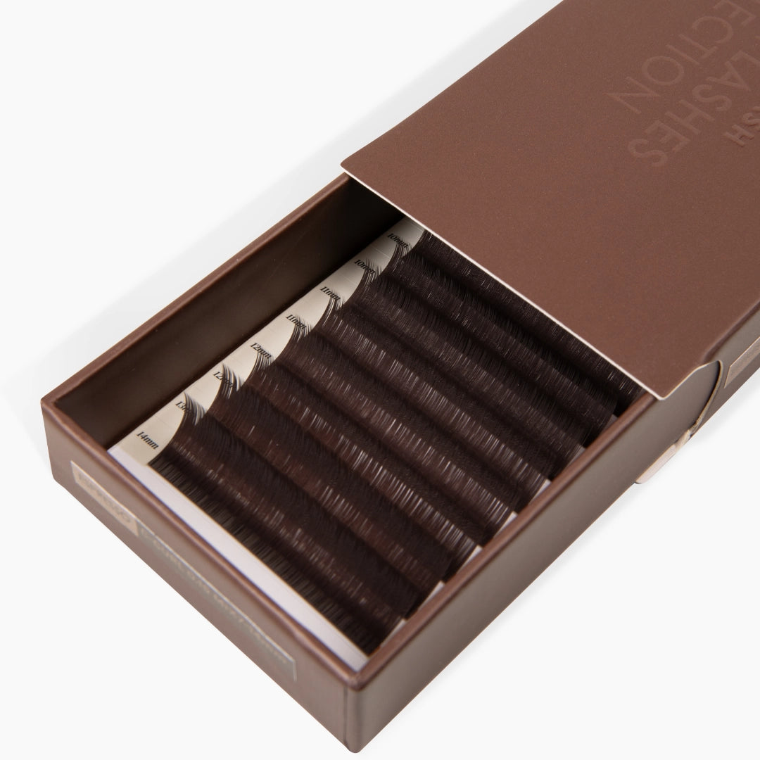 Half open brown eyelash extension tray displayed on a clean white background