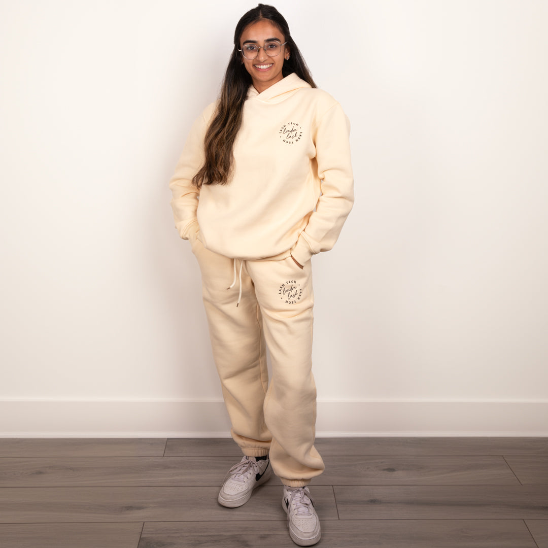 Lash technician wearing London Lash beige hoodie and sweatpants