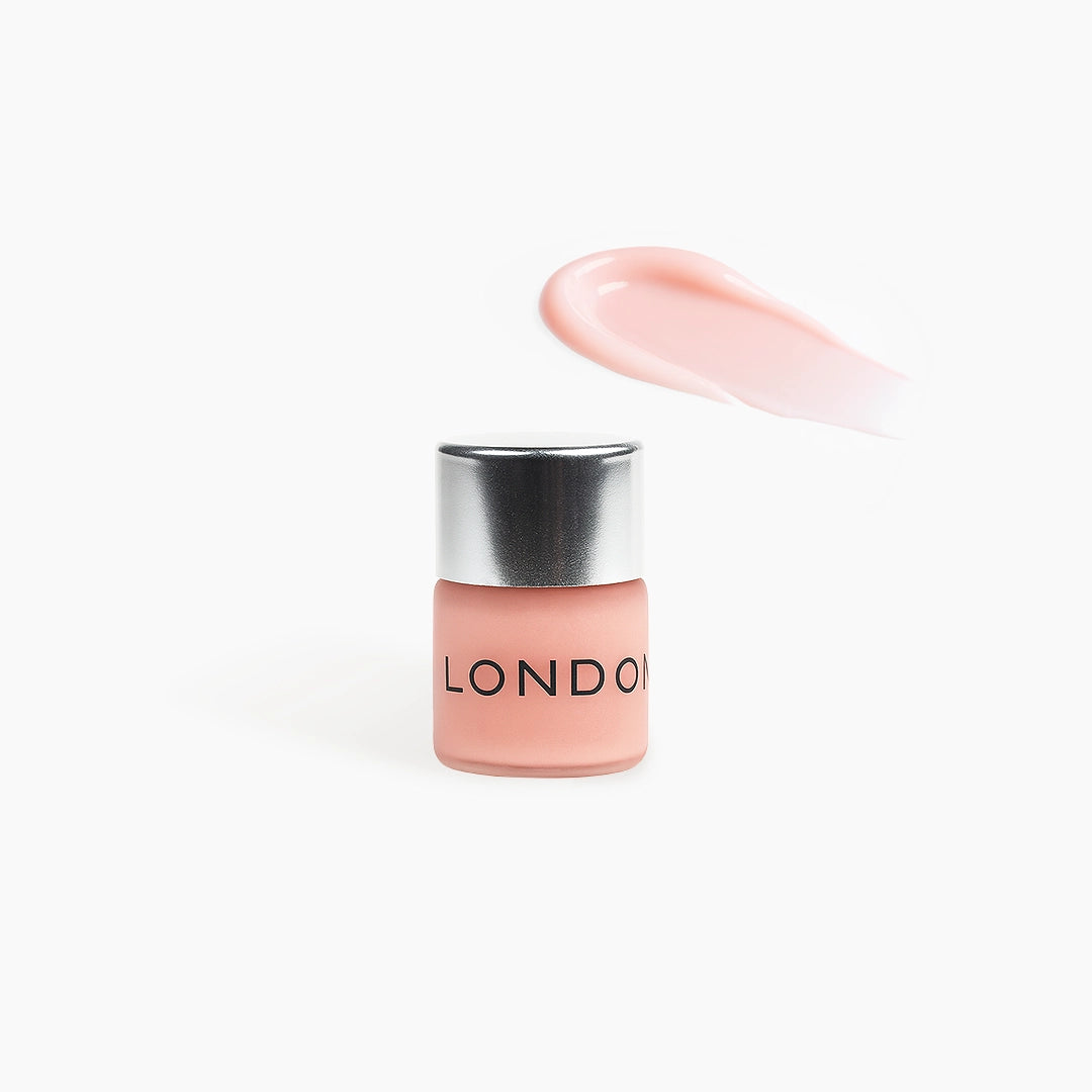 Pink mini cream remover with silver cap on a white background