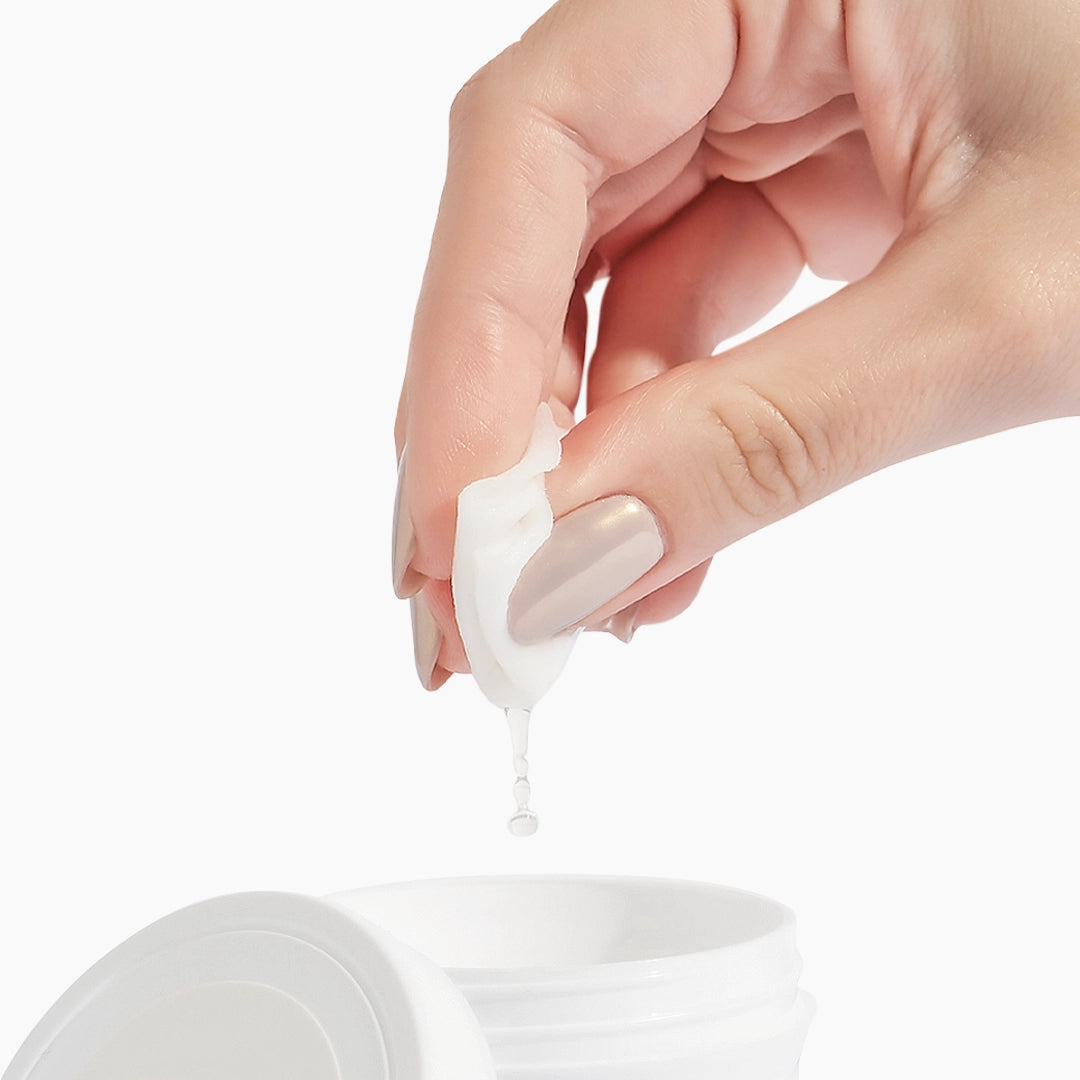 Hand pressing a protein pad from a container on a white background