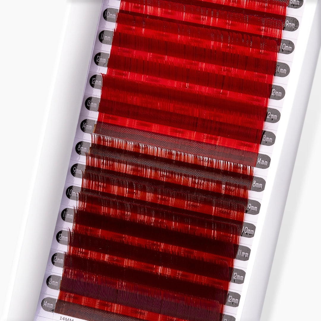 Close up image of red and red brown faux mink coloured lash extension strip on white background