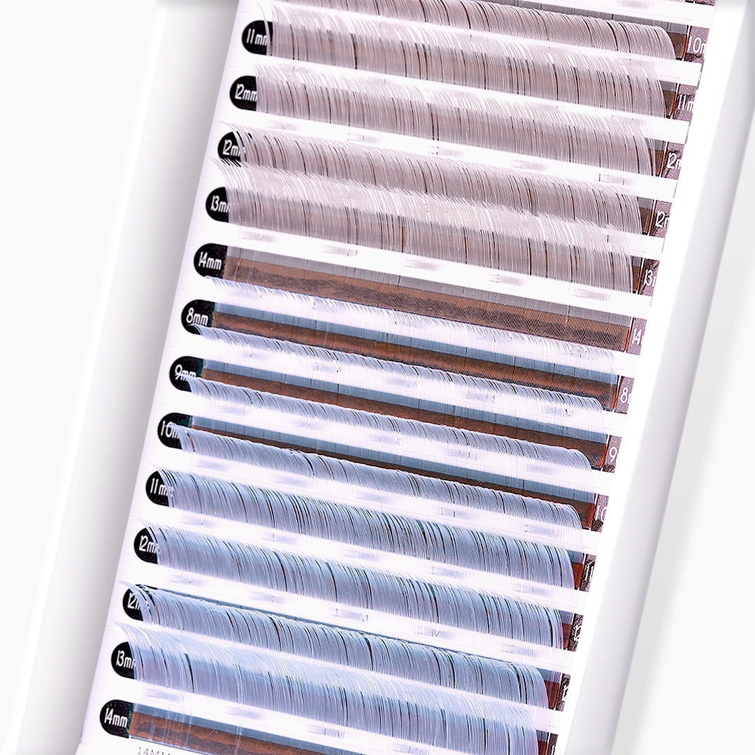Close up image of silver and light blue faux mink coloured lash extension strip and curls on white background
