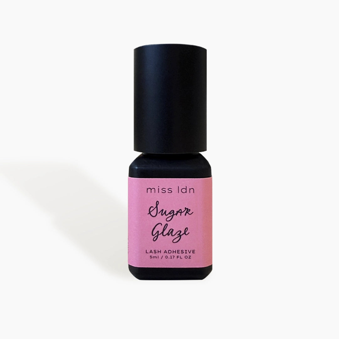 Bottle of miss ldn Sugar Glaze lash adhesive on a white background