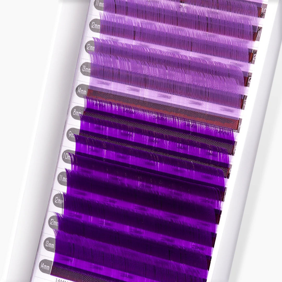 Close up of light violet and violet coloured lash extensions strip on white background