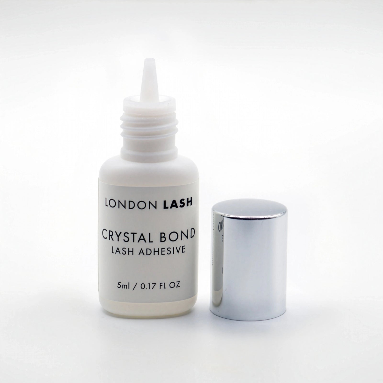 Opened bottle of London Lash Crystal Bond lash adhesive on a white background