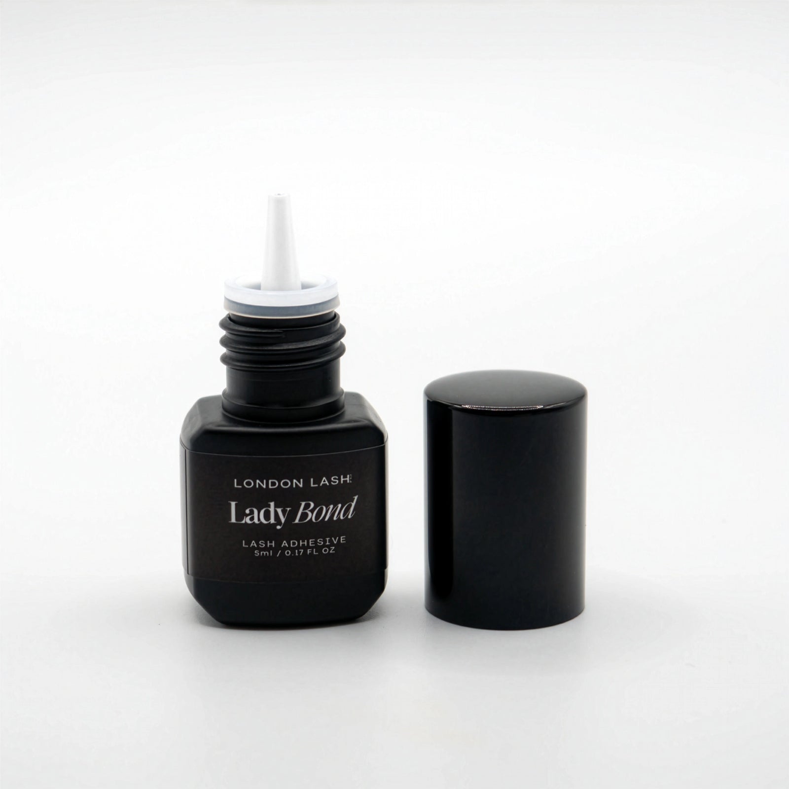Opened bottle of London Lash Lady Bond lash adhesive on a white background