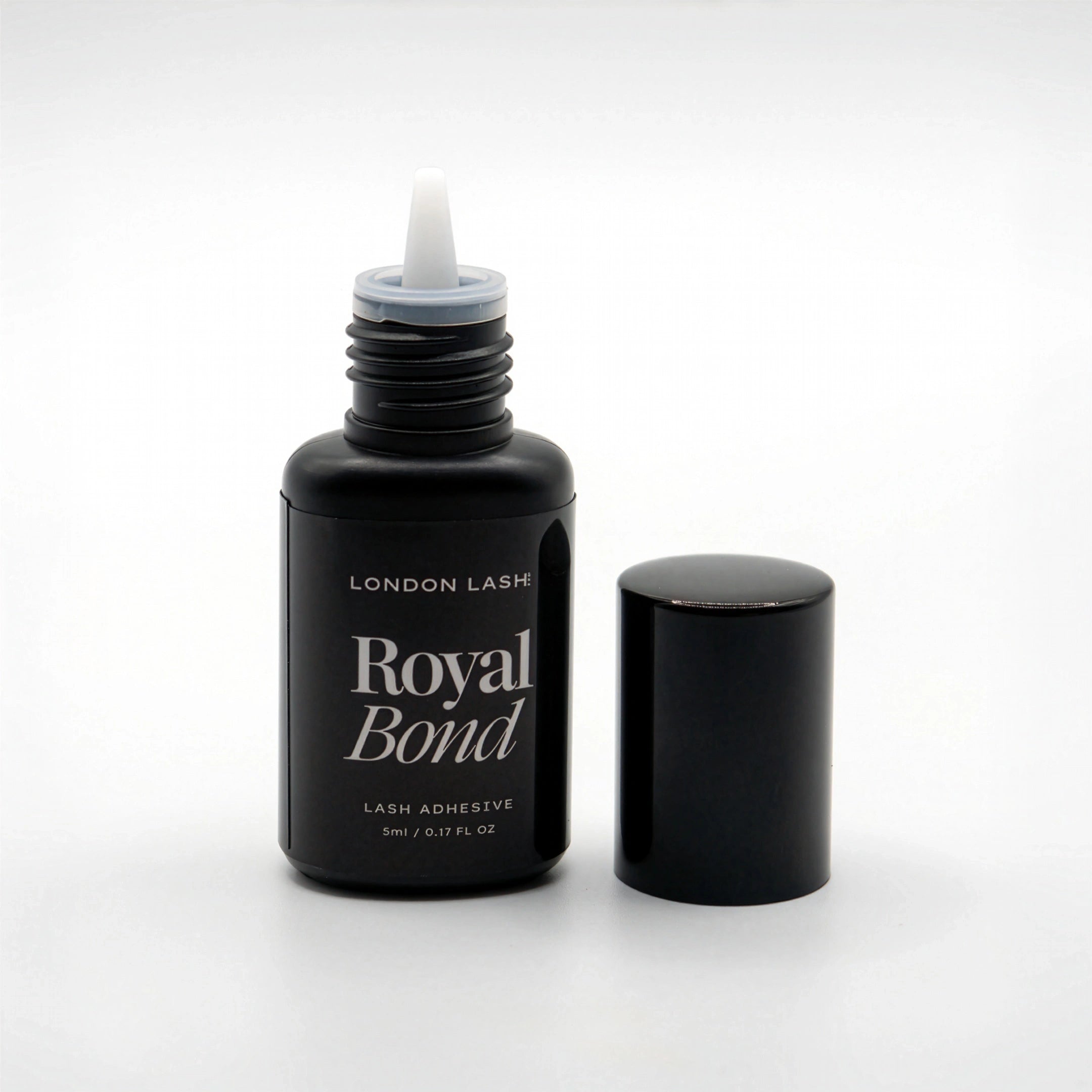 Opened bottle of London Lash Royal Bond lash adhesive on a white background