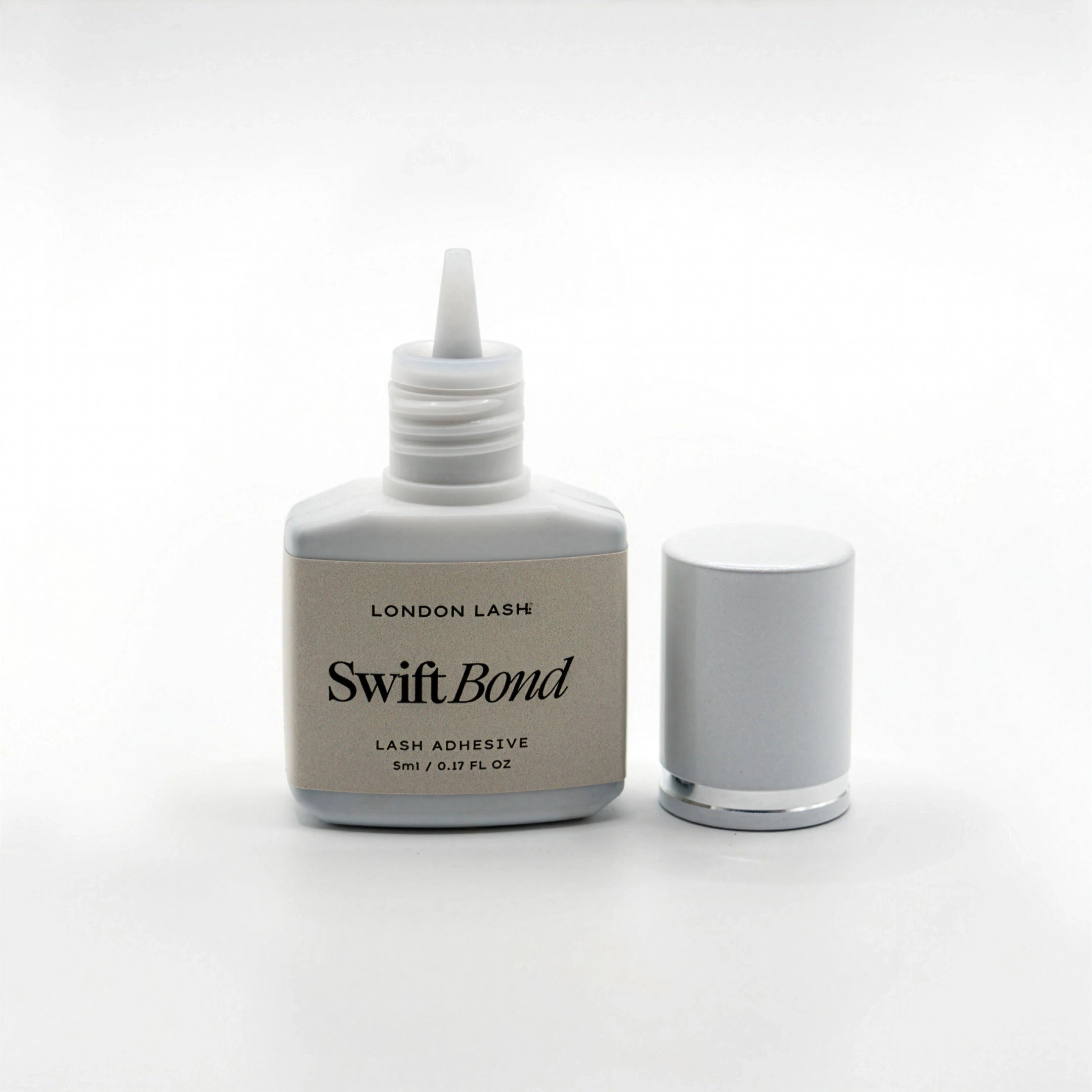 Opened bottle of London Lash Swift Bond lash adhesive on a white background