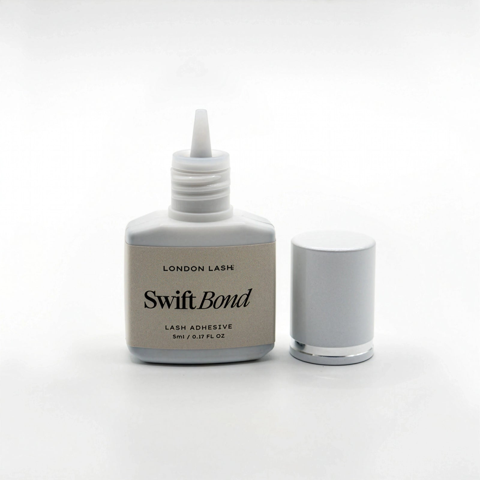 Opened bottle of London Lash Swift Bond lash adhesive on a white background